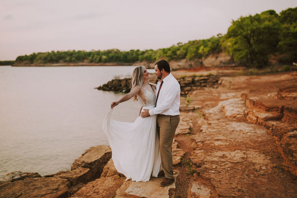 bride and groom have first dance during cliffside sunset elopement