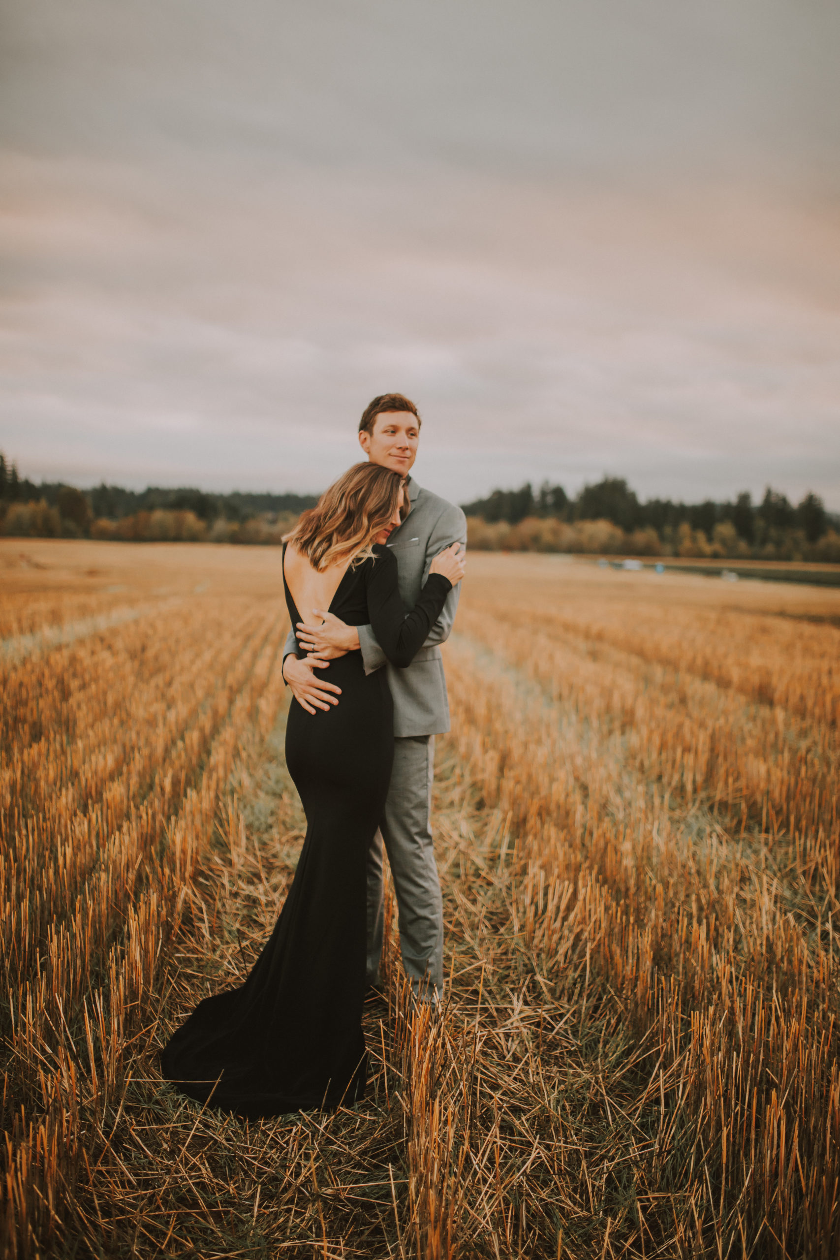 Married couple lean in for an intimate hug at their family farm in Hillsboro Oregon for their Anniversary