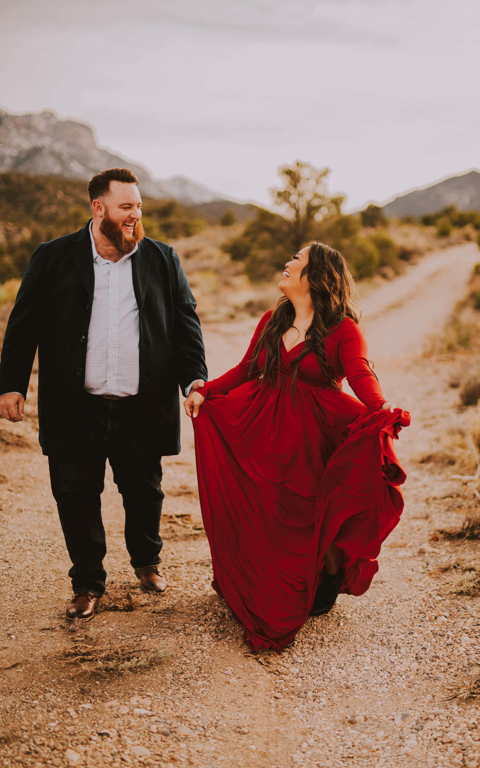 Las Vegas Engagement with bride in a red flow dress and groom in a black and white tuxedo