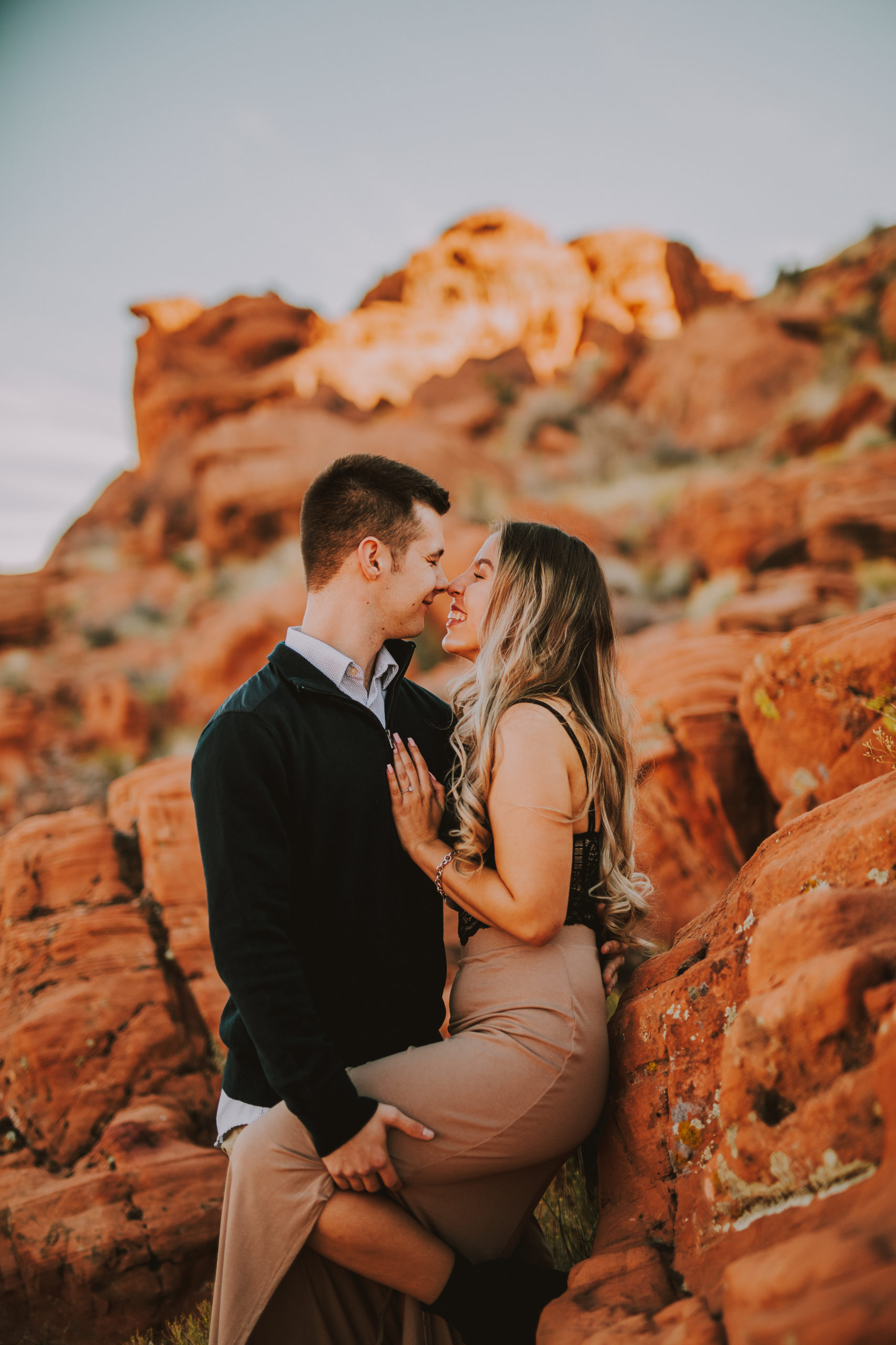 engaged couple leans in for a kiss at the valley of fire in Las Vegas, Nevada