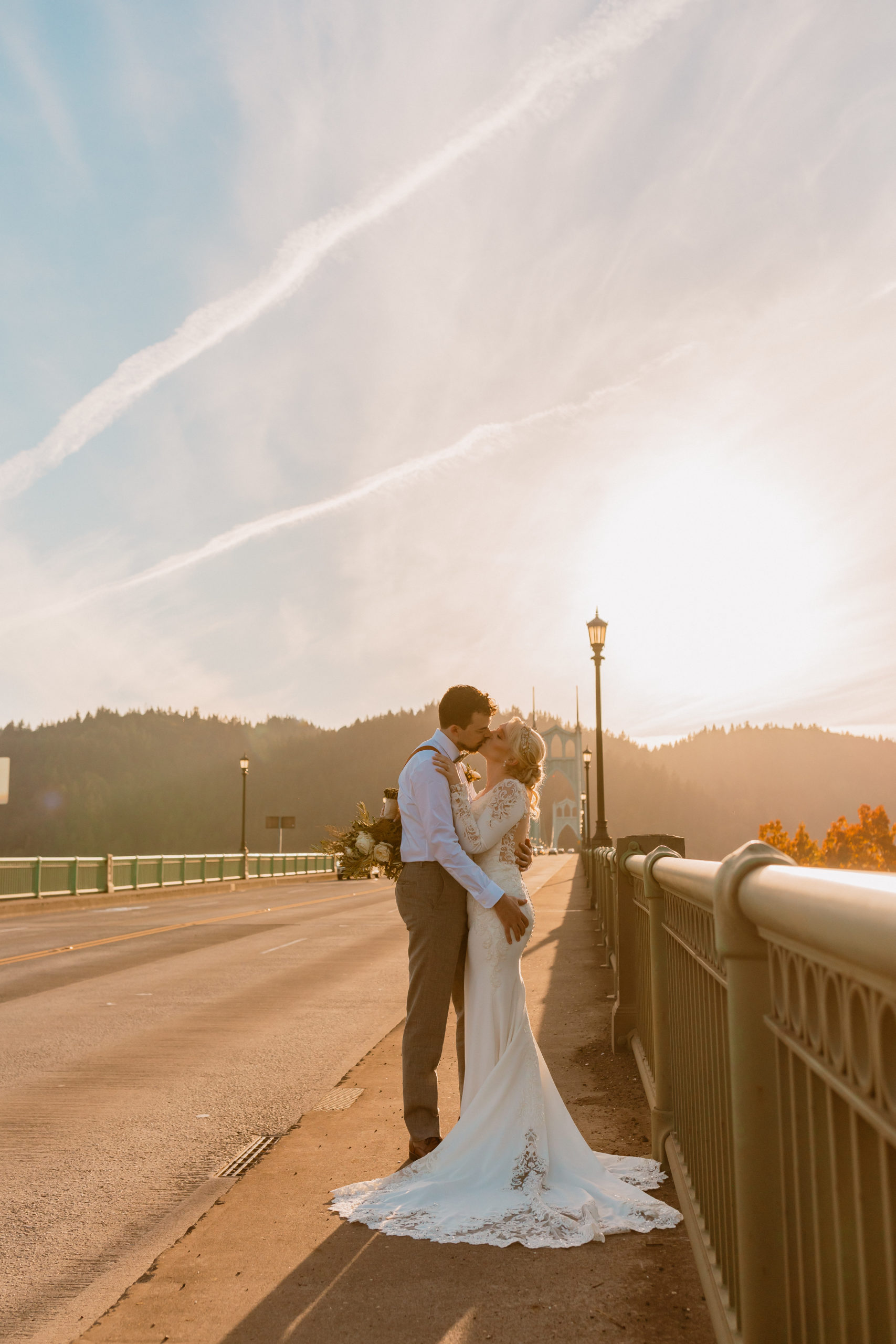 Bride and groom lean in for a kiss on top of a Downtown Portland , Oregon Bridge